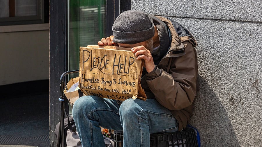 <div class="paragraphs"><p>Homeless man holding a cardboard sign, asking for help in Manhattan downtown. Representative image.</p></div>