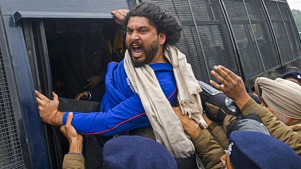 <div class="paragraphs"><p>An agitator being detained during protest march by Quami Insaaf Morcha members towards Punjab Chief Minister Bhagwant Mann’s residence, seeking the release of Sikh prisoners or ‘Bandi Singhs’, in Chandigarh, Tuesday, Jan. 7, 2025</p></div>