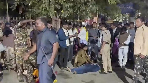 <div class="paragraphs"><p>Police personnel and people gather around a person injured in a stampede-like situation which broke out near Vaikuntha Dwara Darshan ticketing center during distribution of tokens as devotees rushed for 'darshan', in Tirupati, Andhra Pradesh, on Wednesday.</p></div>