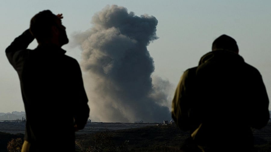 <div class="paragraphs"><p>Israeli soldiers watch as smoke blows in the Gaza Strip, amid the ongoing conflict between Israel and Hamas.&nbsp;</p></div>