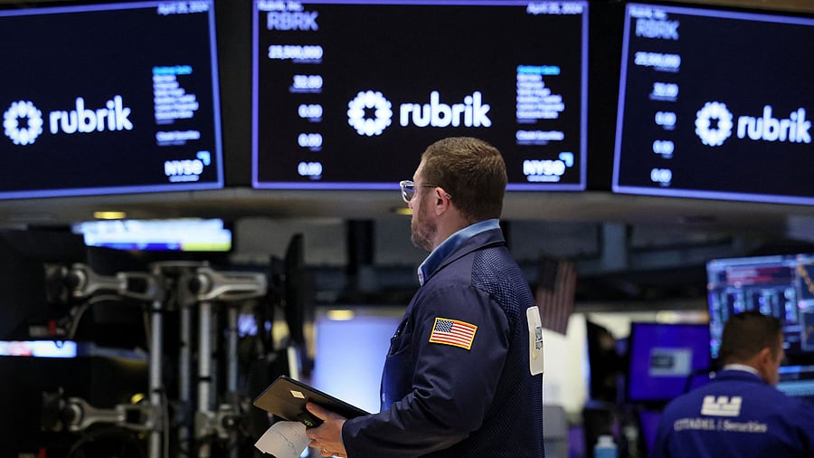 <div class="paragraphs"><p>A trader works as screens display the trading information for Rubrik Inc., the Microsoft backed cybersecurity software startup.</p></div>