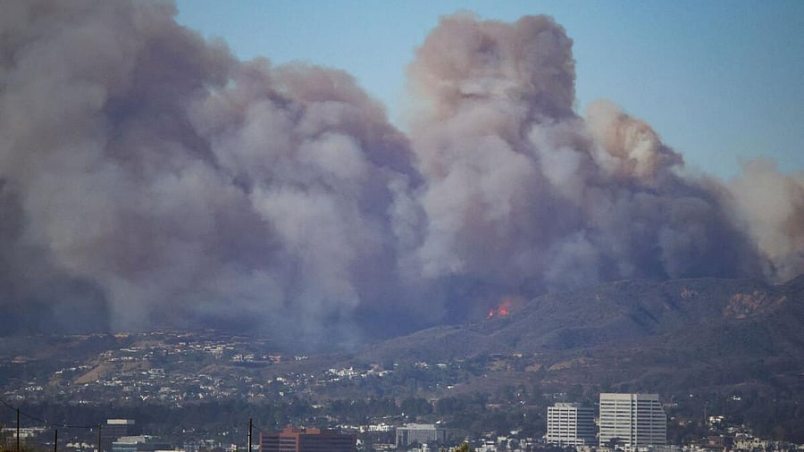 <div class="paragraphs"><p>Smoke rises from a wildfire burning near Pacific Palisades on the west side of Los Angeles during a weather driven windstorm, in Los Angeles, California.</p></div>