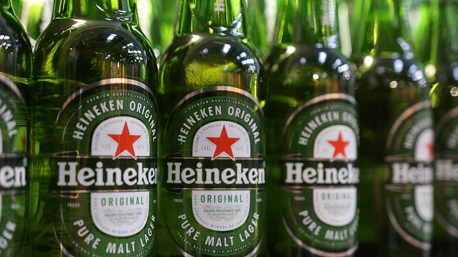 <div class="paragraphs"><p>Bottles of Heineken beer are displayed on a shelf in a supermarket.</p></div>