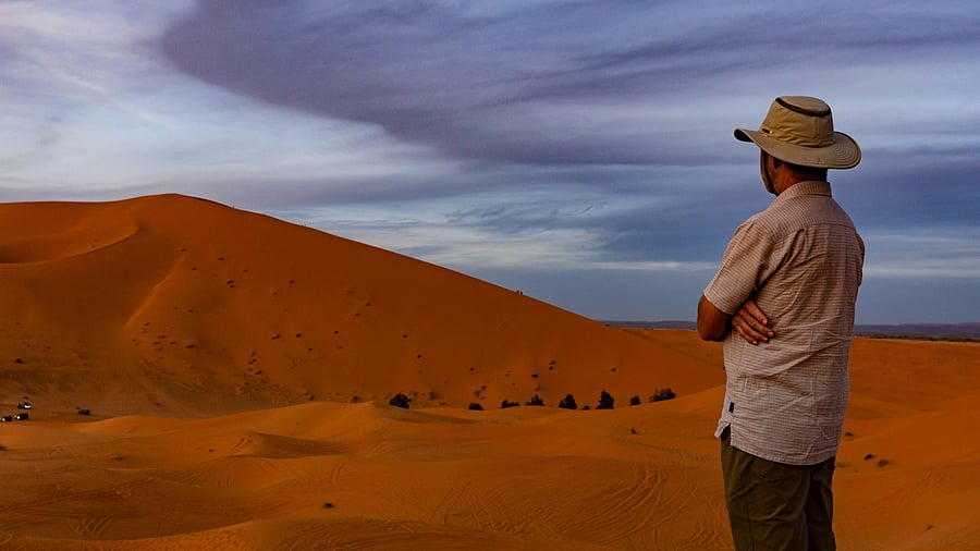 <div class="paragraphs"><p>File Photo: A man looks at the Erg Chebbi sand dunes in the Sahara desert outside Merzouga, Morocco.</p></div>