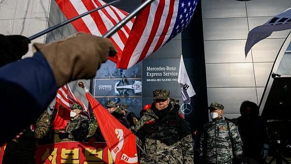 <div class="paragraphs"><p>Pro-Yoon demonstrators hold U.S. and Korean flags as they take part in a rally in support of impeached South Korean President Yoon Suk Yeol near his official residence in Seoul, South Korea January 9, 2025.</p></div>