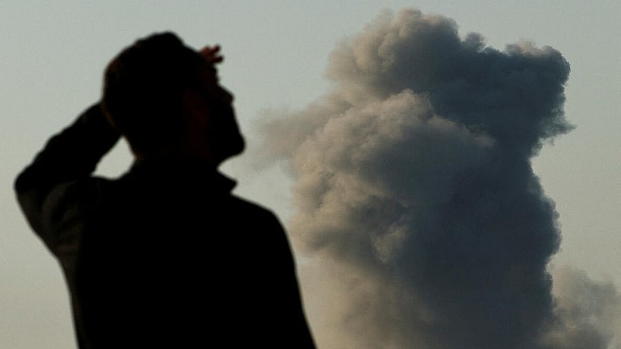 <div class="paragraphs"><p>An Israeli soldier watches as smoke billows in Beit Hanoun, in the Gaza Strip</p></div>