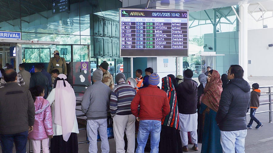 <div class="paragraphs"><p>Passengers look at the display board for information after several flights were delayed or diverted due to bad weather, at the Birsa Munda Airport in Ranchi.</p></div>