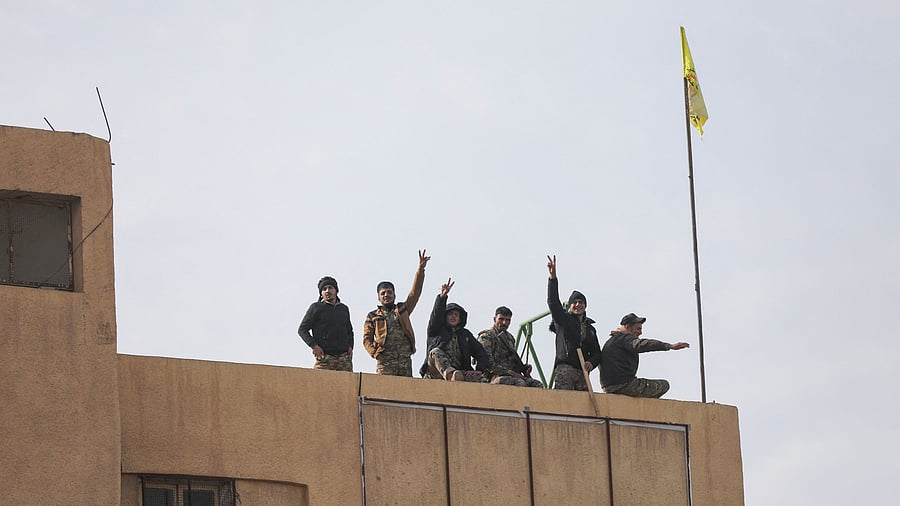<div class="paragraphs"><p>Members of the Kurdish-led Syrian Democratic Forces  gesture in Deir al-Zor, after US-backed alliance led by Syrian Kurdish fighters captured Deir el-Zor, the government's main foothold in the vast desert, according to Syrian sources, in Syria December 7, 2024. </p></div>