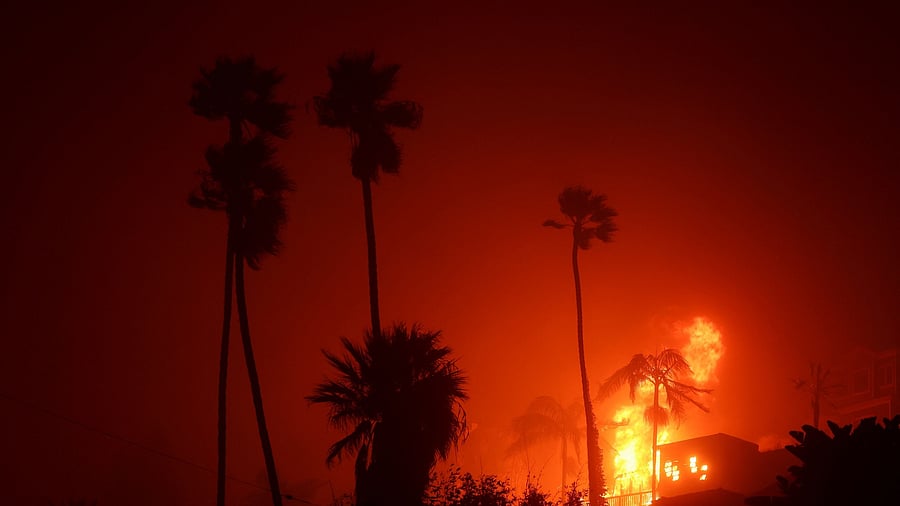 <div class="paragraphs"><p>Flames rise from homes along the Pacific Coast Highway towards Malibu as a wildfire burns in the Pacific Palisades neighborhood of west Los Angeles, California, US.</p></div>