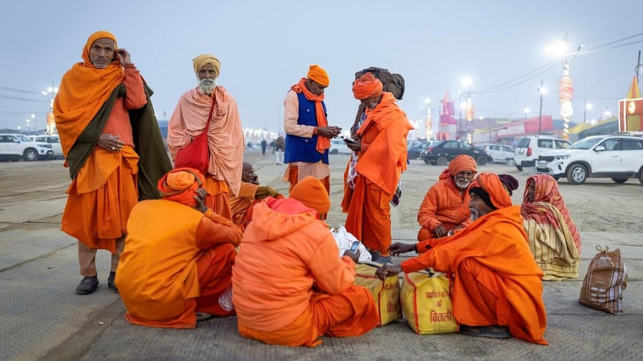 <div class="paragraphs"><p>Hindu devotees sit on the banks of the river Ganges after they arrived to attend the "Maha Kumbh Mela", in Prayagraj.</p></div>