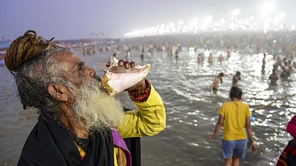 <div class="paragraphs"><p>A devotee blows a conch shell after taking a holy dip at the Sangam on the first day of Maha Kumbh Mela 2025, in Prayagraj, Uttar Pradesh.</p></div>