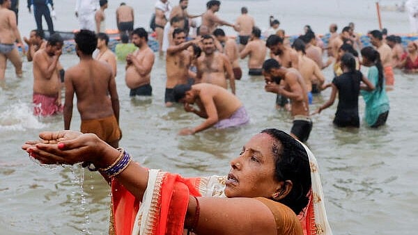 <div class="paragraphs"><p>A woman devotee prays while taking a holy dip at Sangam during the "Maha Kumbh Mela", or the Great Pitcher Festival, in Prayagraj on Monday</p></div>