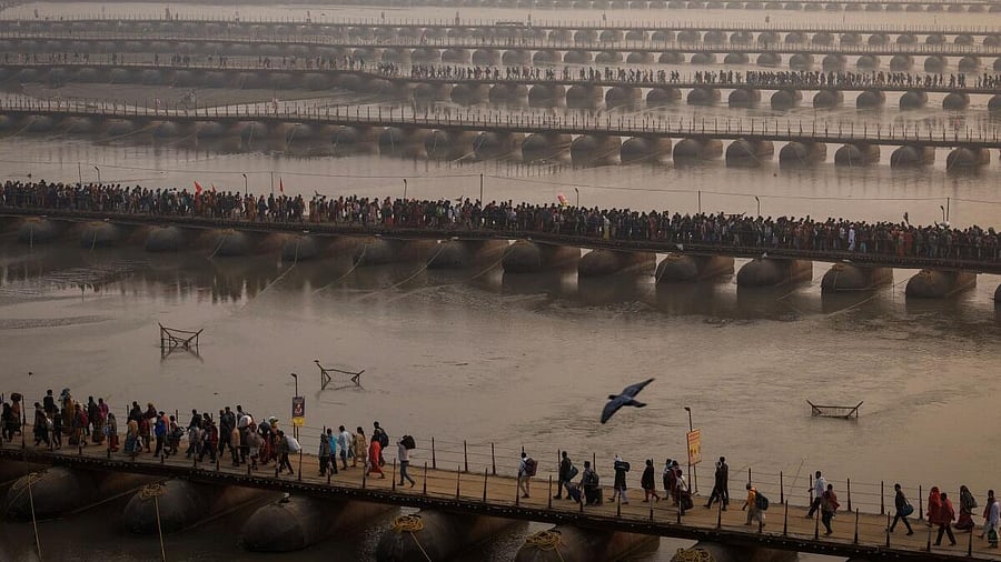 <div class="paragraphs"><p>Devotees cross pontoon bridges to take the holy dip at the Sangam, the confluence of the Ganges and Yamuna and Saraswati rivers during the Maha Kumbh Mela. </p></div>