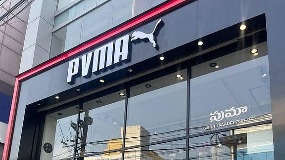 <div class="paragraphs"><p>'PVMA' written on a board outside a Puma store.</p></div>