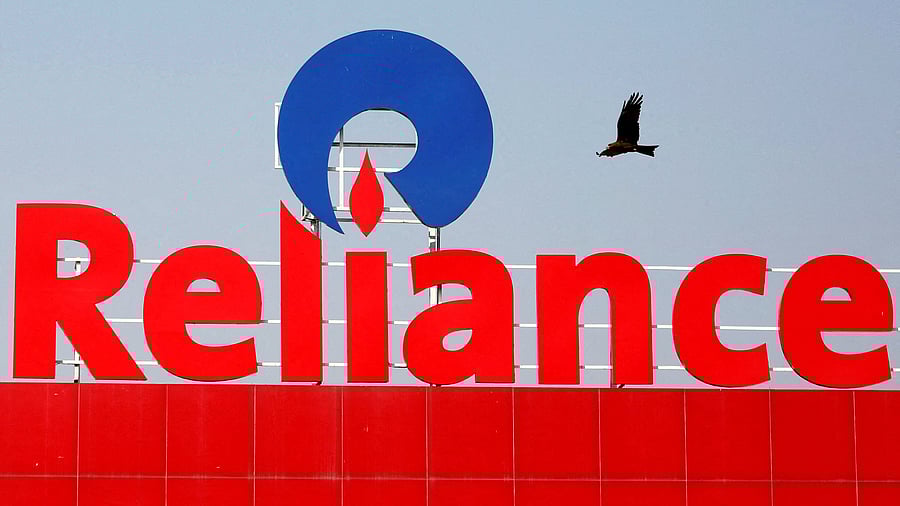 <div class="paragraphs"><p>A bird flies past a Reliance Industries logo installed on its mart in Ahmedabad, India January 16, 2017.</p></div>