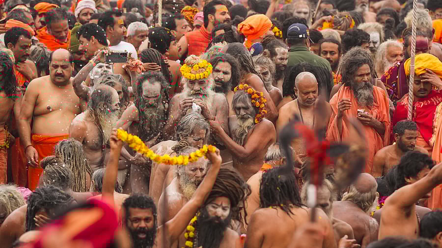 <div class="paragraphs"><p>Naga Sadhus' of 'Juna Akhara' take a holy dip at Sangam on the occasion of 'Makar Sankranti' during the Maha Kumbh Mela 2025, in Prayagraj, Uttar Pradesh, Tuesday, Jan. 14, 2025.</p></div>