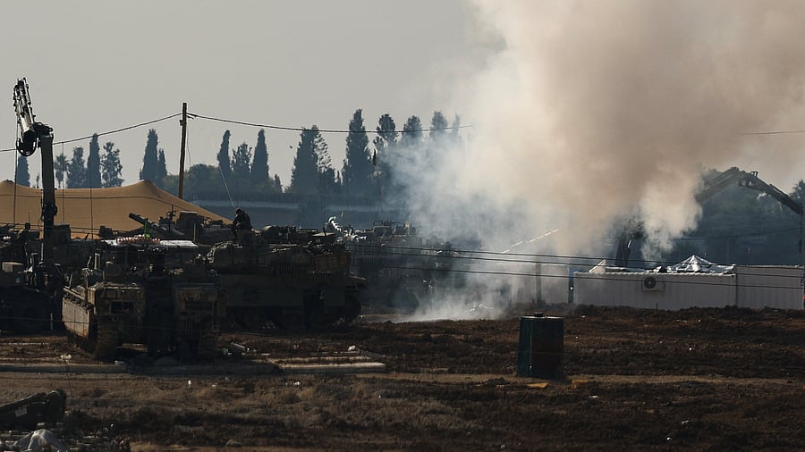 <div class="paragraphs"><p>An Israeli soldier sits on top of a tank at a camp, amid the ongoing conflict between Israel and Hamas, near the Israel-Gaza border, in Israel</p></div>