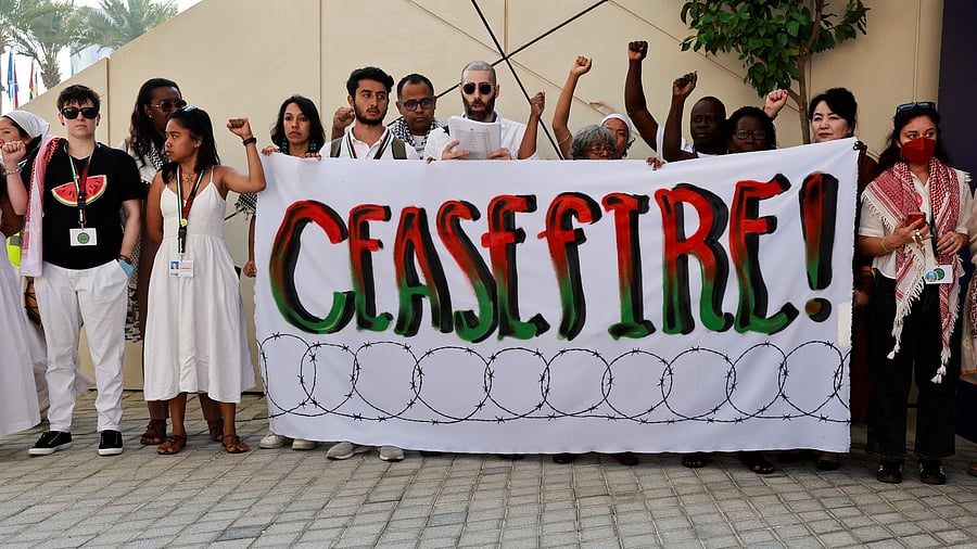 <div class="paragraphs"><p>File Photo: Activists hold a banner that says "Ceasefire" during a protest in support of Palestinians in Gaza, amid the ongoing conflict between Israel and the Palestinian Islamist group Hamas, at the United Nations Climate Change Conference in Dubai, United Arab Emirates.</p></div>