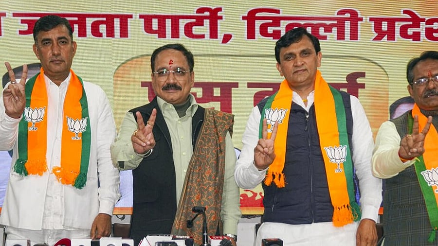 <div class="paragraphs"><p>Delhi BJP President Virendra Sachdeva (second from left) with MoS and party leader Harsh Malhotra as two AAP councillors Ravinder Solanki and Narender Girsa join the party, in New Delhi.</p></div>