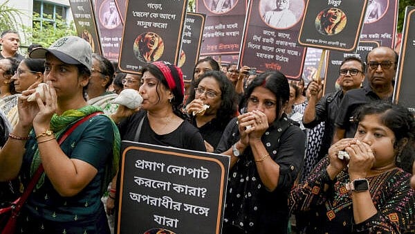 <div class="paragraphs"><p>Women wearing black dresses blow conches during a protest rally demanding justice for the victim of R G Kar Medical College and Hospital incident, in Kolkata.</p></div>