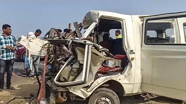 <div class="paragraphs"><p>People gather near the wreckage of a vehicle at the site after a tempo hit a minivan, causing it to ram into a stationary bus on the Pune-Nashik Highway, Friday, Jan. 17</p></div>