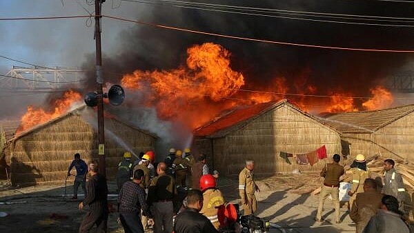 <div class="paragraphs"><p>Firefighters try to douse fire in makeshift tents during the ongoing Maha Kumbh Mela in Prayagraj on January 19, 2025.</p></div>