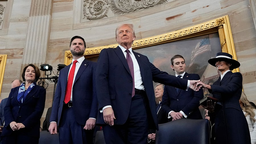<div class="paragraphs"><p>US President Donald Trump, center, holds the hand of his wife Melania Trump, far right, as their son Barron Trump, Vice President JD Vance, and Sen. </p></div>