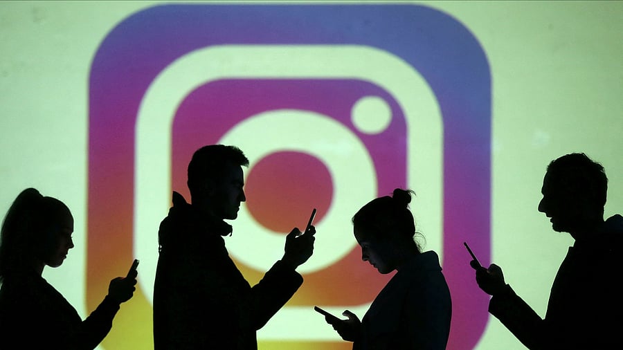 <div class="paragraphs"><p>FILE PHOTO: Silhouettes of mobile users are seen next to a screen projection of Instagram logo in this picture illustration.</p></div>