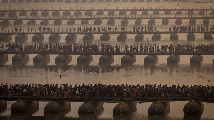 <div class="paragraphs"><p>Devotees cross pontoon bridges on the day they take a holy dip at Sangam, the confluence of the Ganges and Yamuna rivers with the mythical, invisible Saraswati river, during the "Maha Kumbh Mela", or the Great Pitcher Festival, in Prayagraj</p></div>