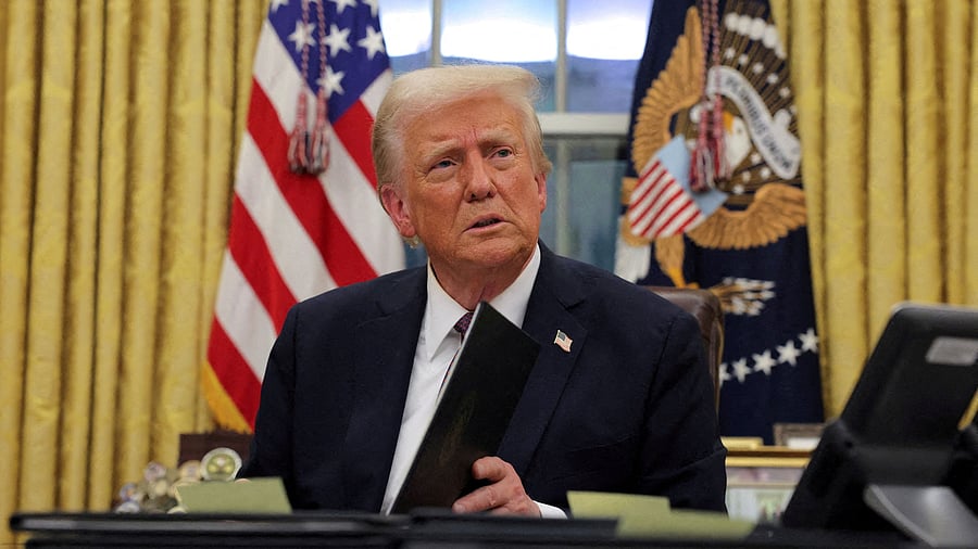 <div class="paragraphs"><p> US President Donald Trump signs documents.</p></div>