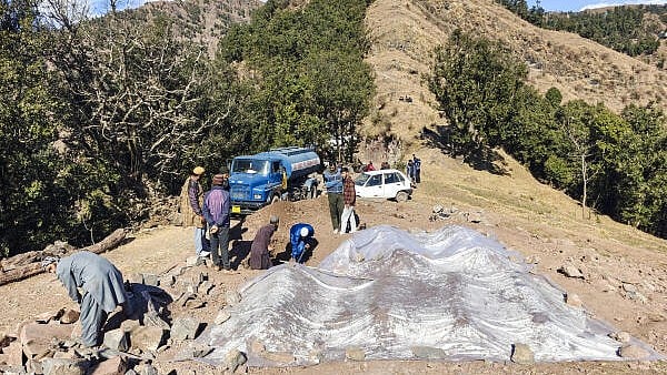 <div class="paragraphs"><p>People dig a grave for the burial of Yasmeen Kouser, the 17th victim of the 'mysterious' illness, in Badhaal village of Rajouri district.</p></div>