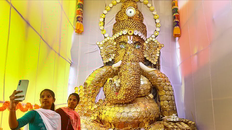 <div class="paragraphs"><p>Devotees click a selfie with an idol of Lord Ganesh.</p></div>
