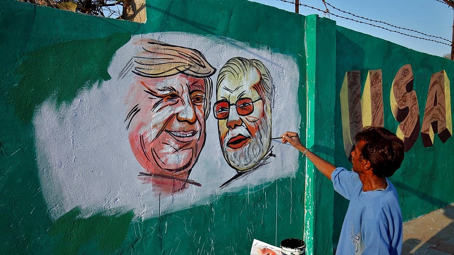 <div class="paragraphs"><p>A man applies finishing touches to paintings of US President Trump and India's PM Modi, in Ahmedabad ahead of Trump's 2020 India visit.</p></div>