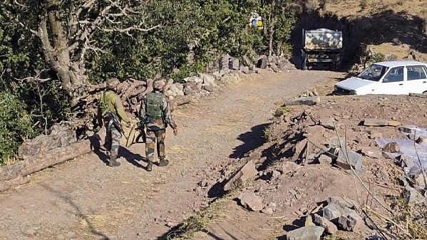 <div class="paragraphs"><p>Security personnel keep vigil after the remote Badhaal village was declared a containment zone  in the wake of the death of 17 people belonging to three families, in Jammu and Kashmir's Rajouri district, on Wednesday.</p></div>