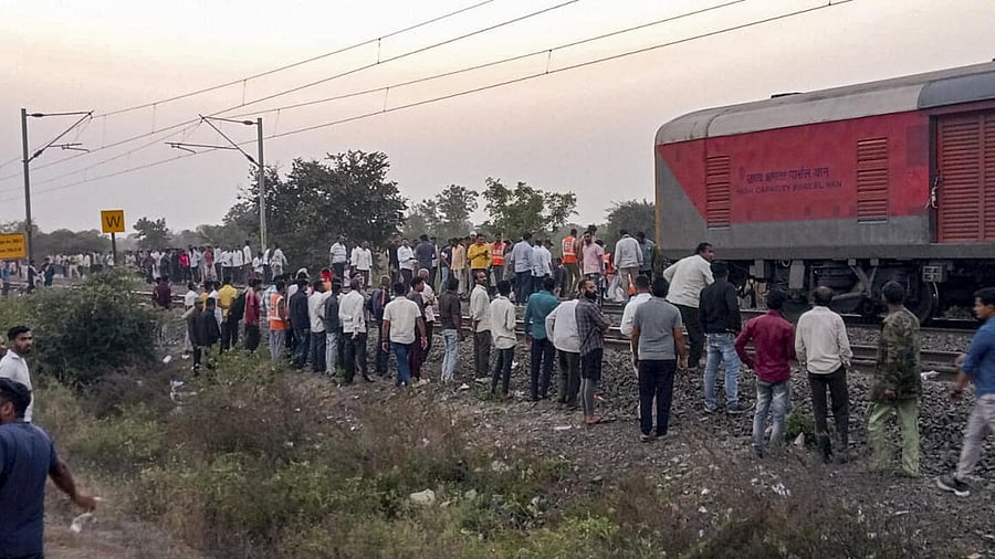 <div class="paragraphs"><p>People gather after a train mishap, in Jalgaon district, Maharashtra, Wednesday, Jan. 22, 2025.</p></div>