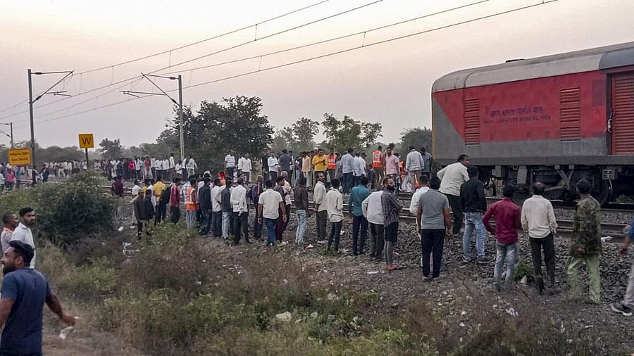 <div class="paragraphs"><p>People gather after a train mishap, in Jalgaon district, Maharashtra, Wednesday, Jan. 22, 2025. At least 13 passengers were killed on Wednesday evening when they jumped from their train in panic due to a `fire incident', only to be run over by another train on the adjacent tracks in North Maharashtra's Jalgaon district, officials said. </p></div>