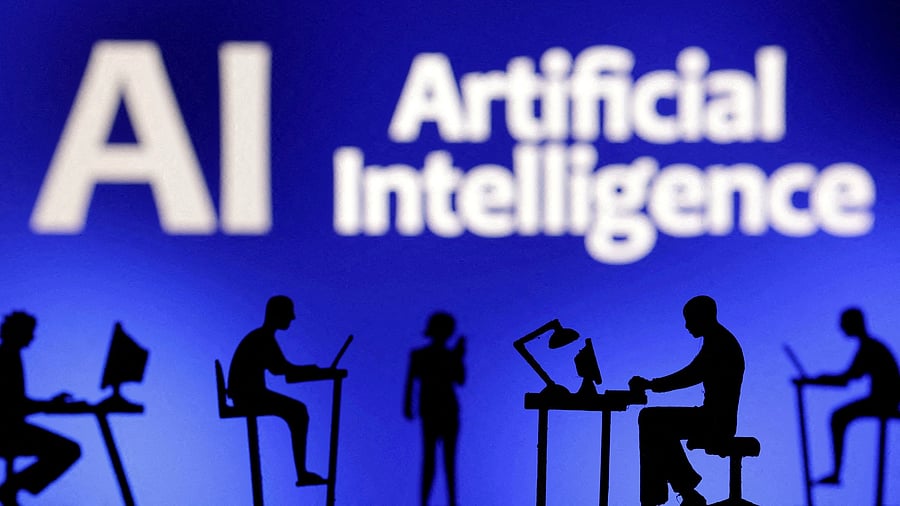 <div class="paragraphs"><p>Figurines with computers and smartphones are seen in front of the words "Artificial Intelligence AI" in this illustration </p></div>