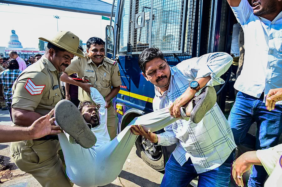 <div class="paragraphs"><p>Police personnel detain a protester during the ‘Rail Roko’ movement launched by KKCCI and other organisations in Kalaburagi on Friday.</p></div>