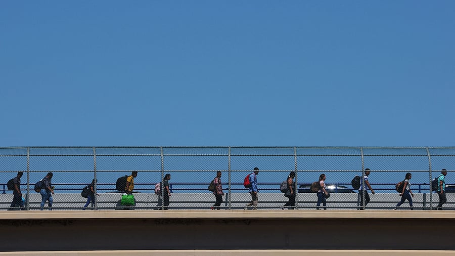 <div class="paragraphs"><p>Migrants cross the Eagle Pass International Bridge from Mexico to the US a legal point of entry above a point where many migrants wade across the Rio Grande, for their scheduled appointments with immigration authorities, in Eagle Pass, Texas, U.S., September 28, 2023.  </p></div>