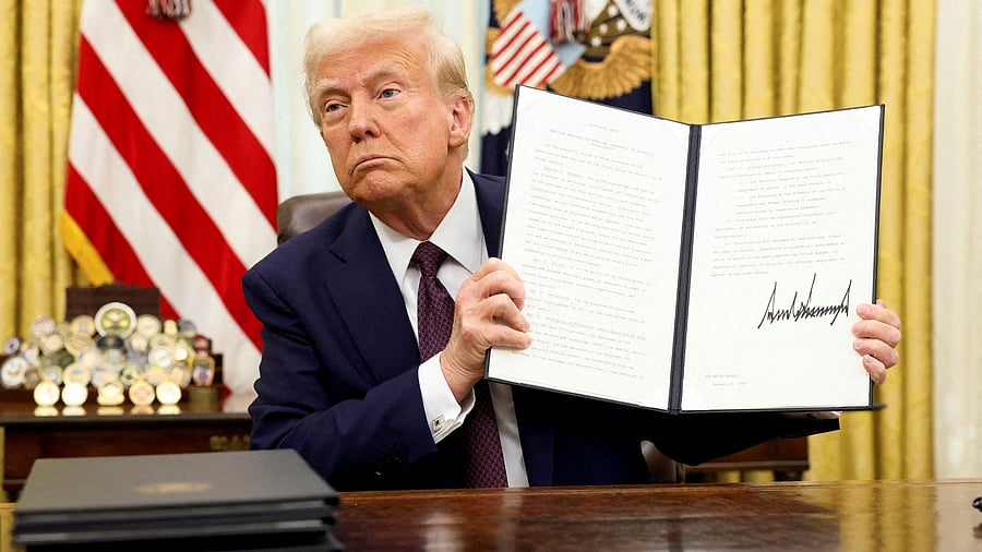<div class="paragraphs"><p>US President Donald Trump holds a signed executive order.</p></div>