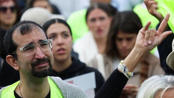 <div class="paragraphs"><p>People react as they watch broadcasts related to the release of Israeli hostages, who have been held in Gaza since the deadly October 7, 2023 attack by Hamas, as part of a prisoner-hostage exchange deal between Israel and Hamas, at a public square dedicated to hostages in Tel Aviv, Israel. </p></div>