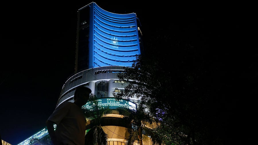 <div class="paragraphs"><p>A man walks past the lit-up Bombay Stock Exchange building </p></div>