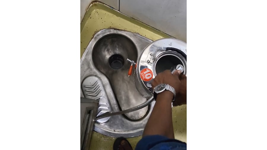 <div class="paragraphs"><p>Screengrab of the tea vendor washing his container in the train toilet.</p></div>