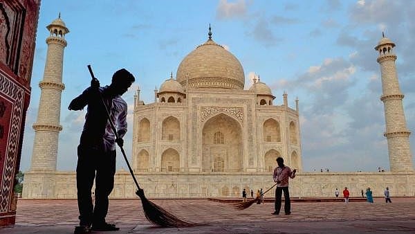 <div class="paragraphs"><p>Workers sweep the premises of Taj Mahal</p></div>