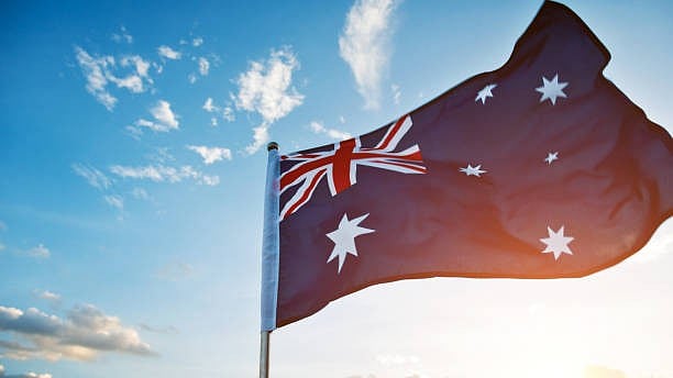 <div class="paragraphs"><p>Waving Australia flag in the air.</p></div>