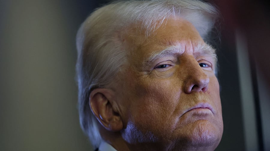 <div class="paragraphs"><p>US President Donald Trump looks on as reporters ask questions aboard Air Force One during a flight from Las Vegas, Nevada, to Miami, Florida, US, January 25, 2025. </p></div>