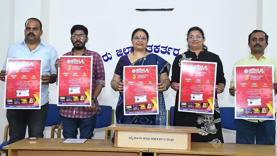 <div class="paragraphs"><p>Members of the Mysuru Cinema Society release the poster of the third International Festival of Short Films and Documentaries in Mysuru, on Monday. Jogi Manju, G R Chetan, Padmavati Bhat, Seema Burude, and Venugopal are seen in the image.</p></div>