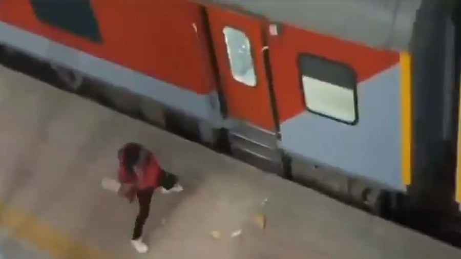 <div class="paragraphs"><p>Screengrab from a video showing a passenger hurling a rock towards a train in MP.</p></div>