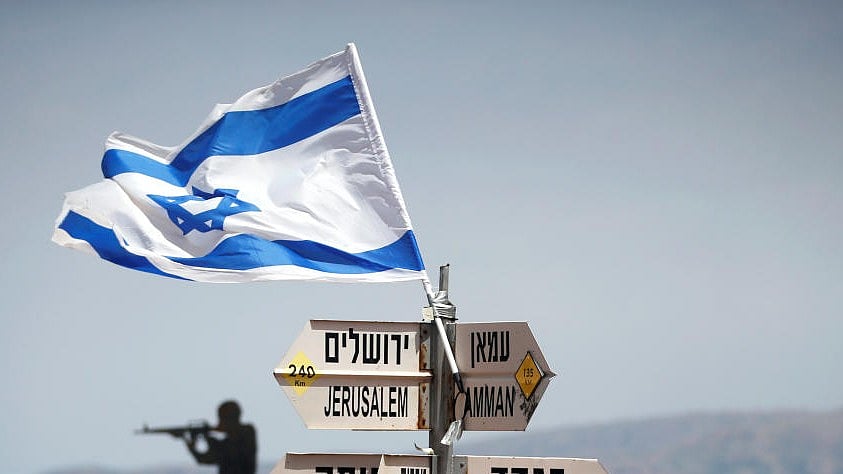<div class="paragraphs"><p>An Israeli soldier stands next to signs pointing out distances to different cities, on Mount Bental. (Representative image)</p></div>