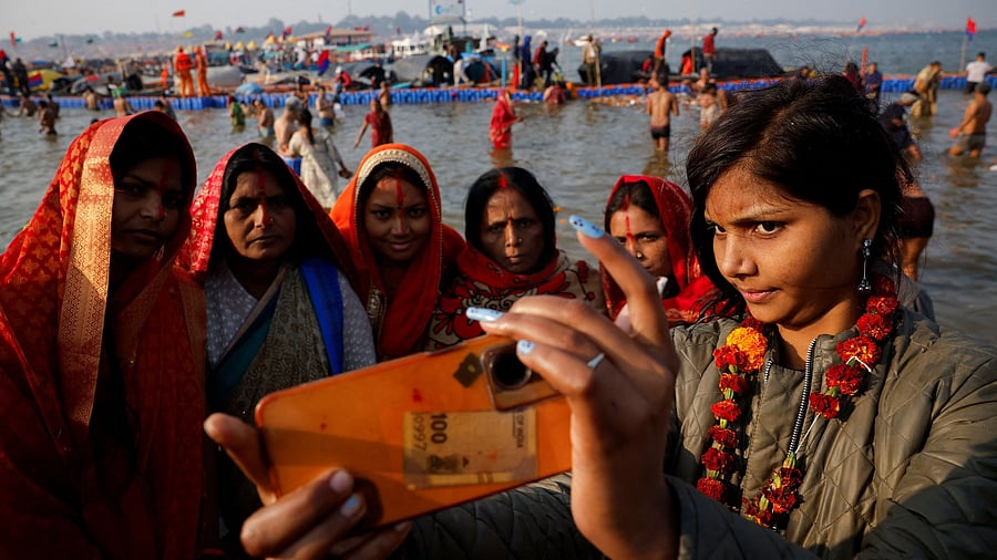 <div class="paragraphs"><p>Devotees take a selfie at the banks of Sangam, the confluence of the Ganges and Yamuna rivers with the mythical, invisible Saraswati river, during the "Maha Kumbh Mela", or the Great Pitcher Festival, in Prayagraj, January 28, 2025.</p></div>